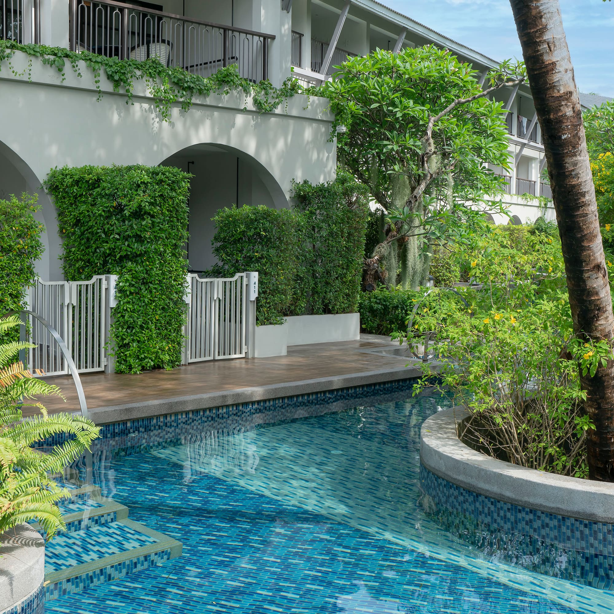 a pool with plants around it