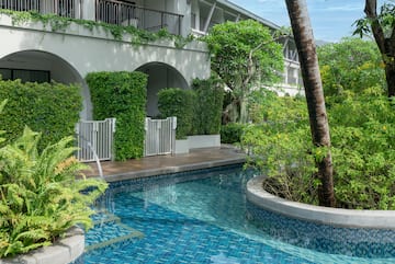 a pool with plants around it