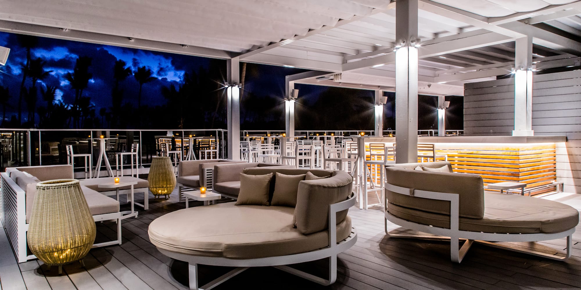 a patio with round chairs and tables
