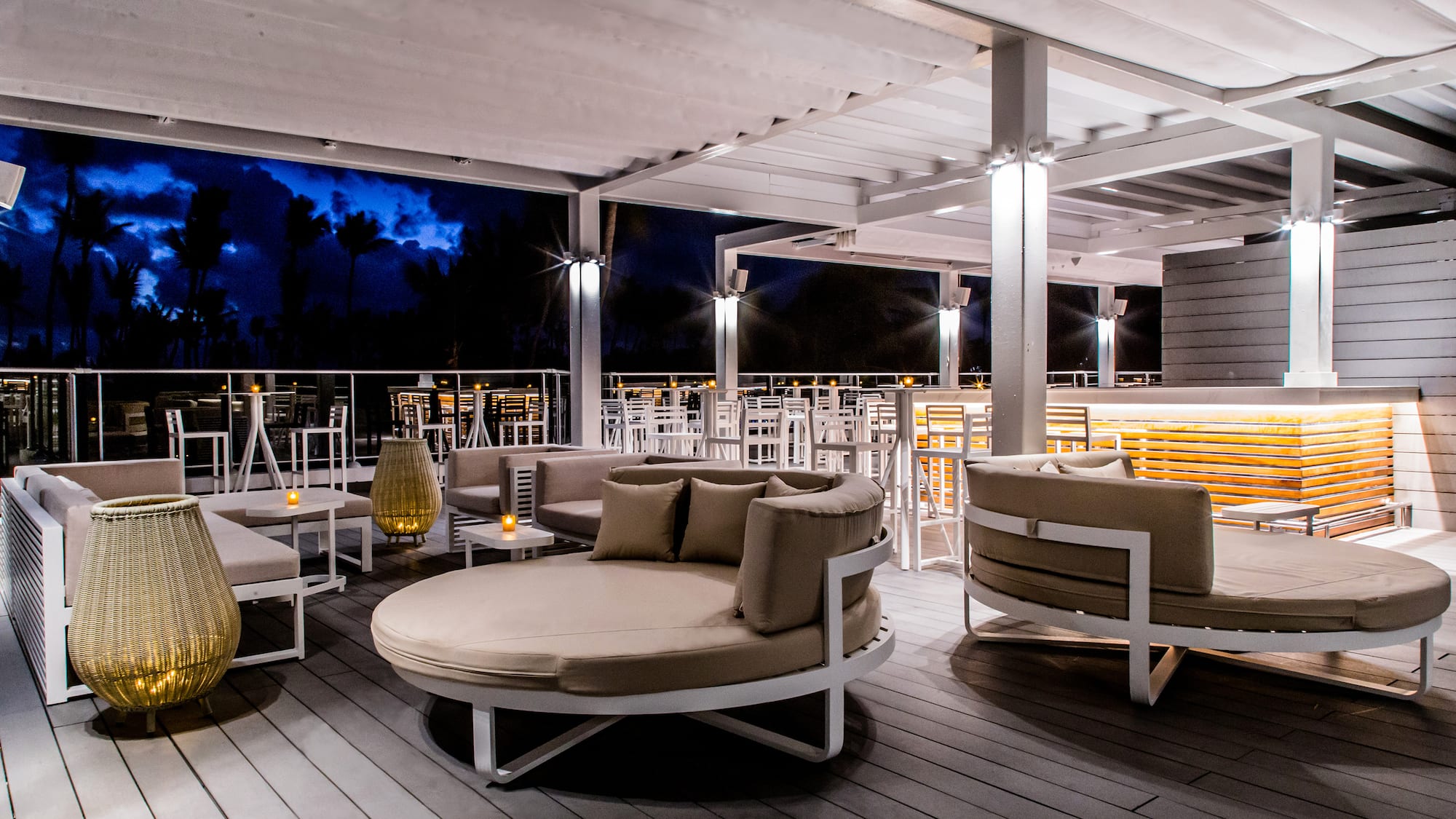 a patio with round chairs and tables
