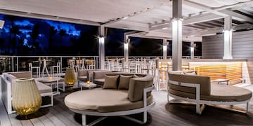 a patio with round chairs and tables