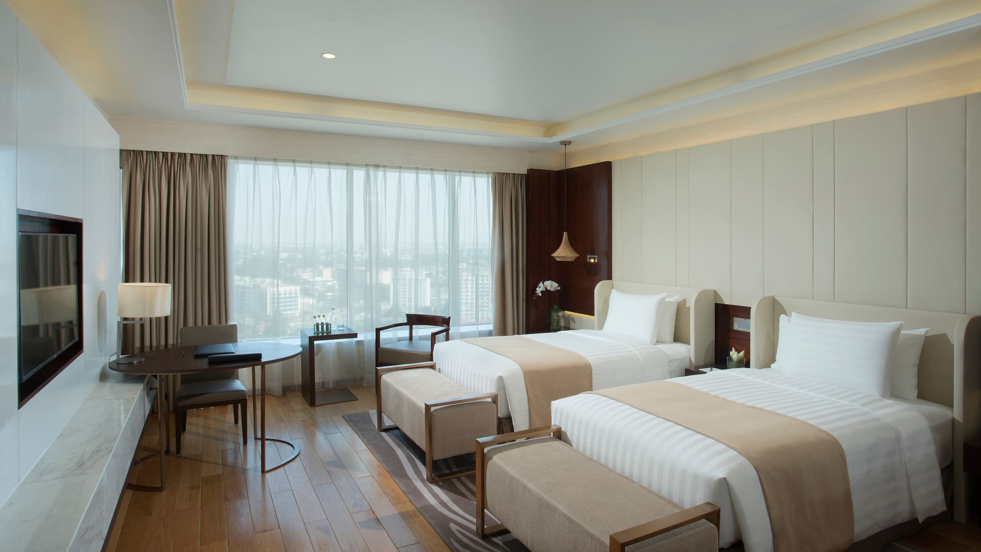 a room with two beds and a table