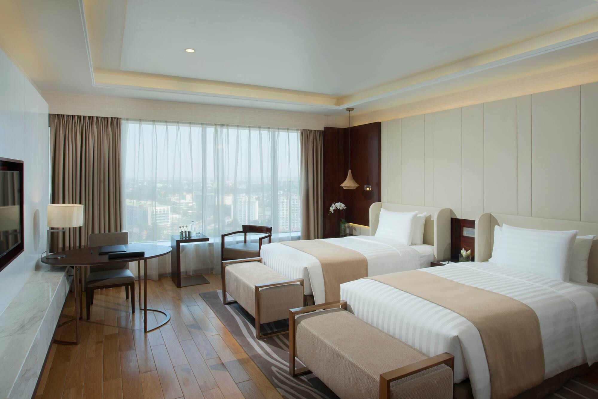 a room with two beds and a table