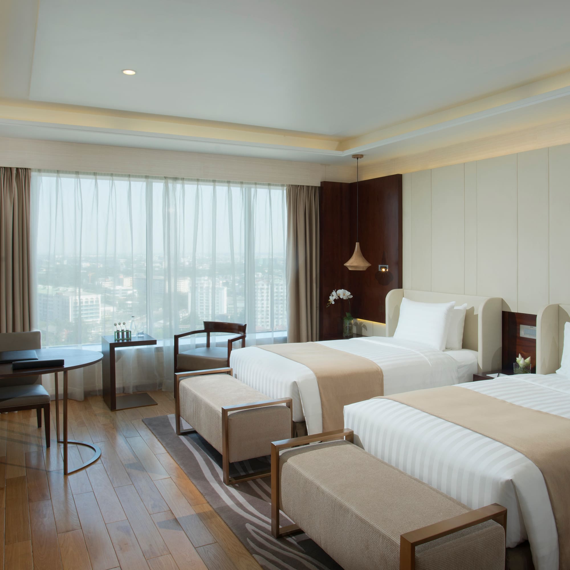 a room with two beds and a table