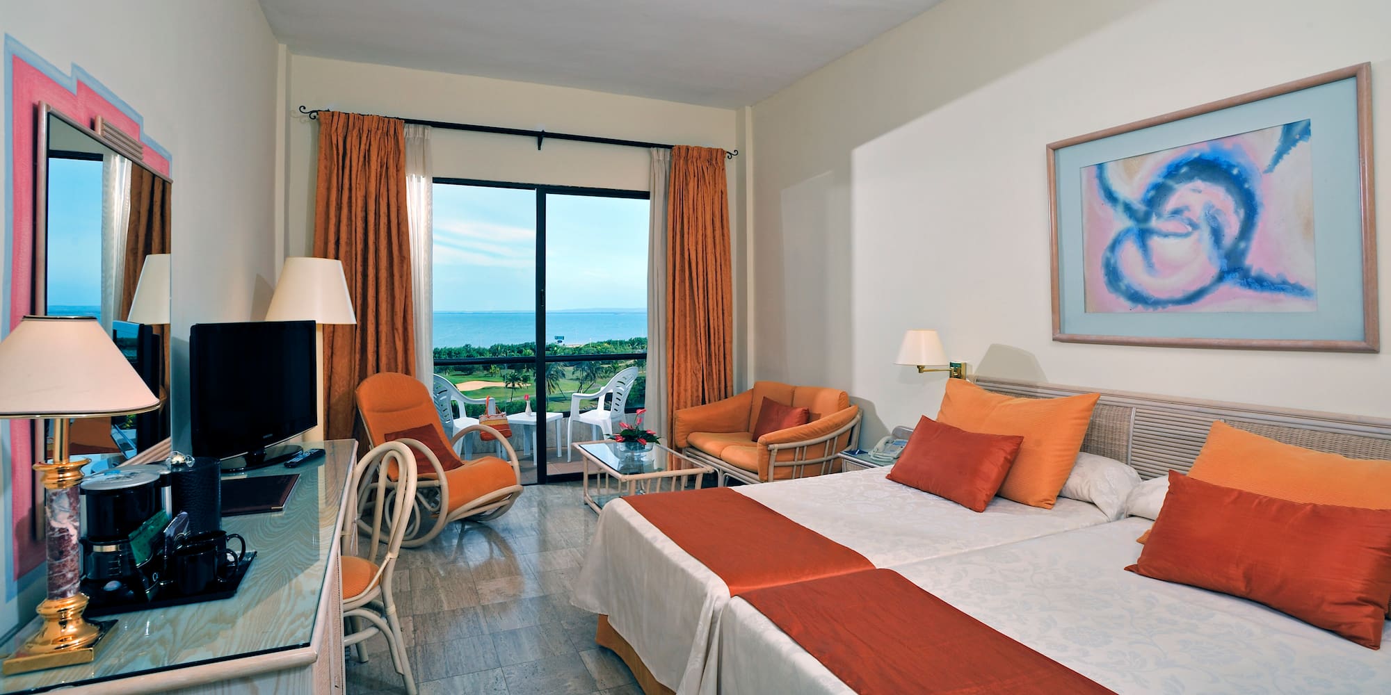 a room with two beds and a television