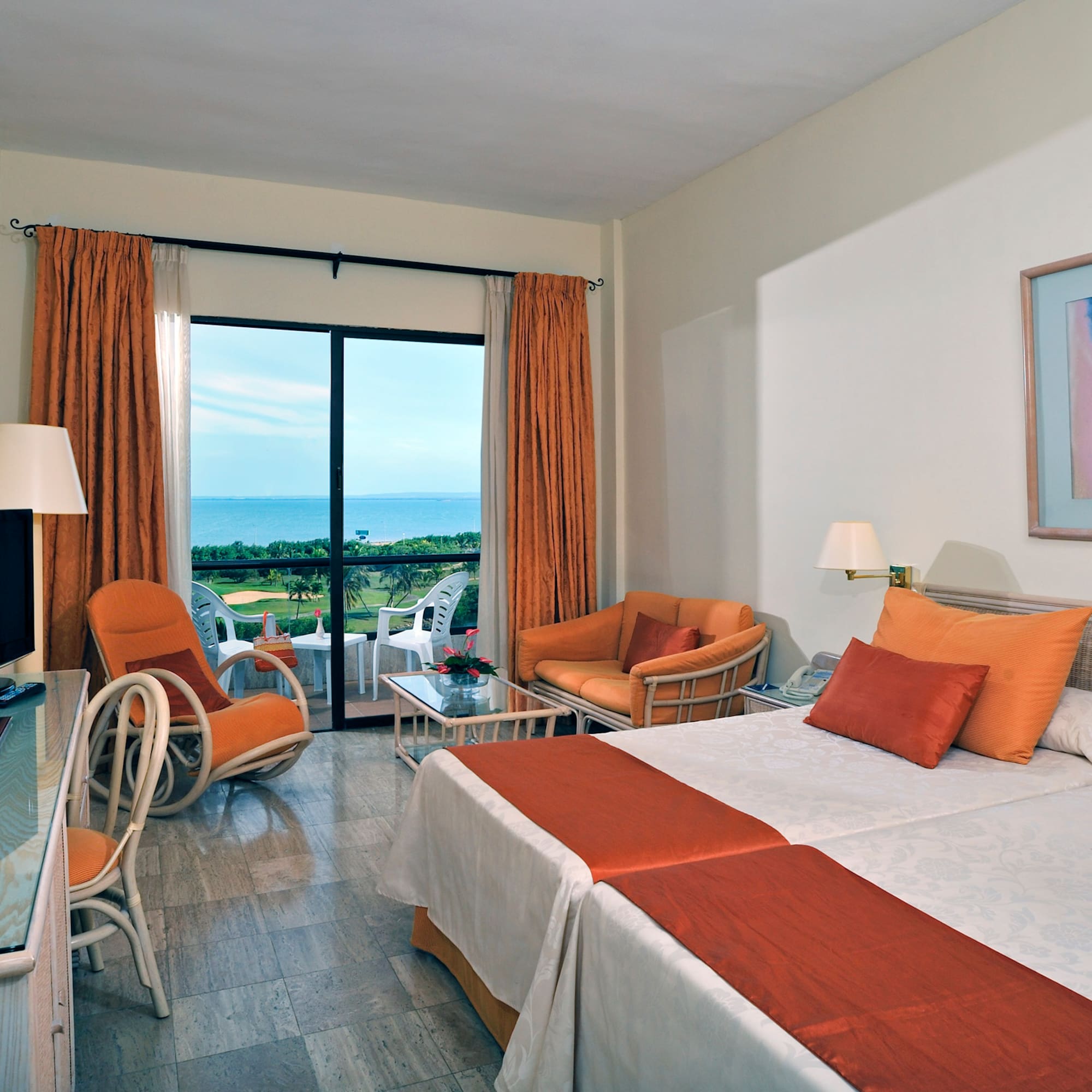 a room with two beds and a television