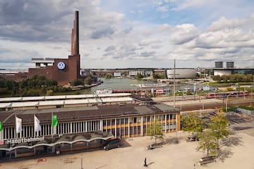 a city with a river and a factory