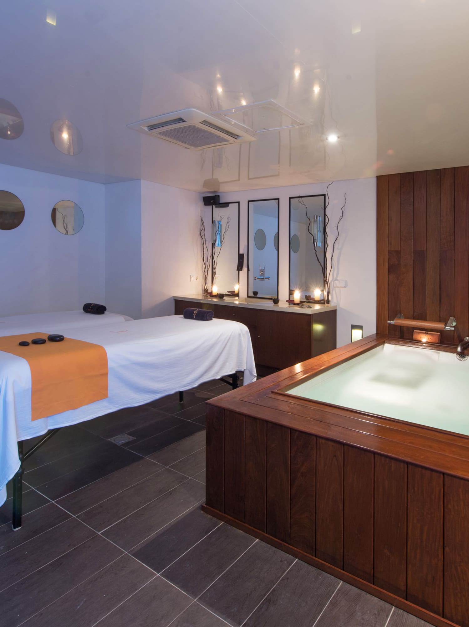 a room with a hot tub and massage beds