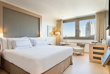 a bedroom with a bed and a table and chairs