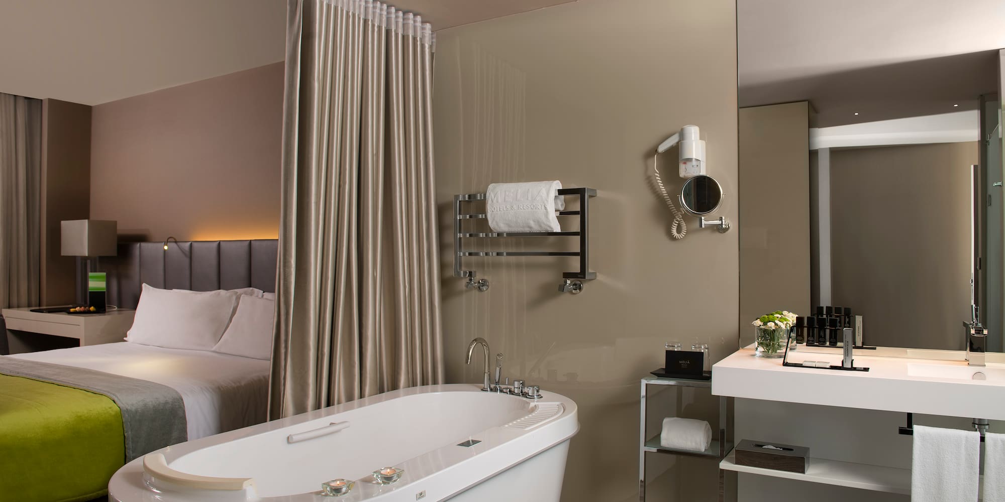 a bathroom with a bathtub and a bed