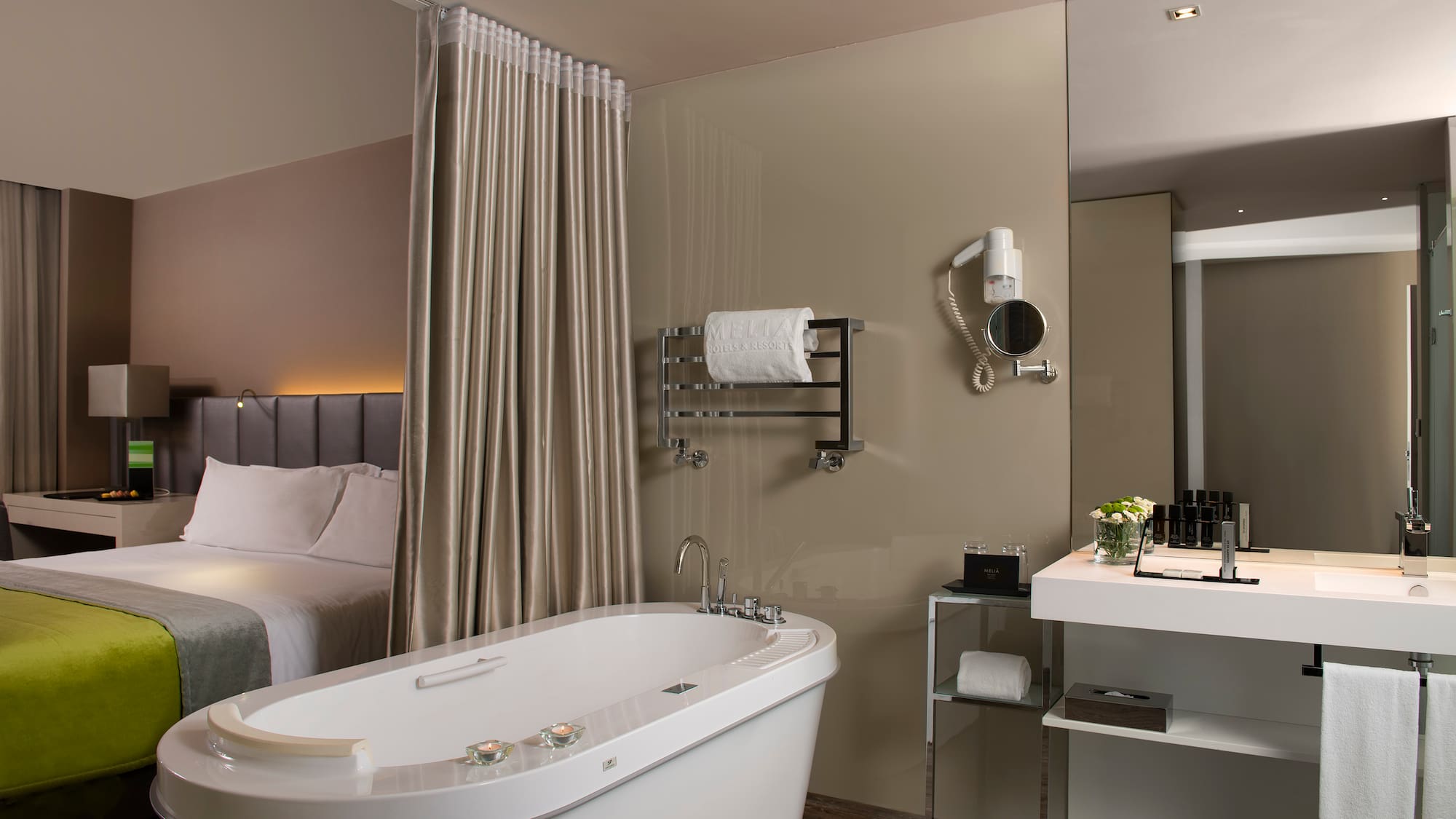 a bathroom with a bathtub and a bed