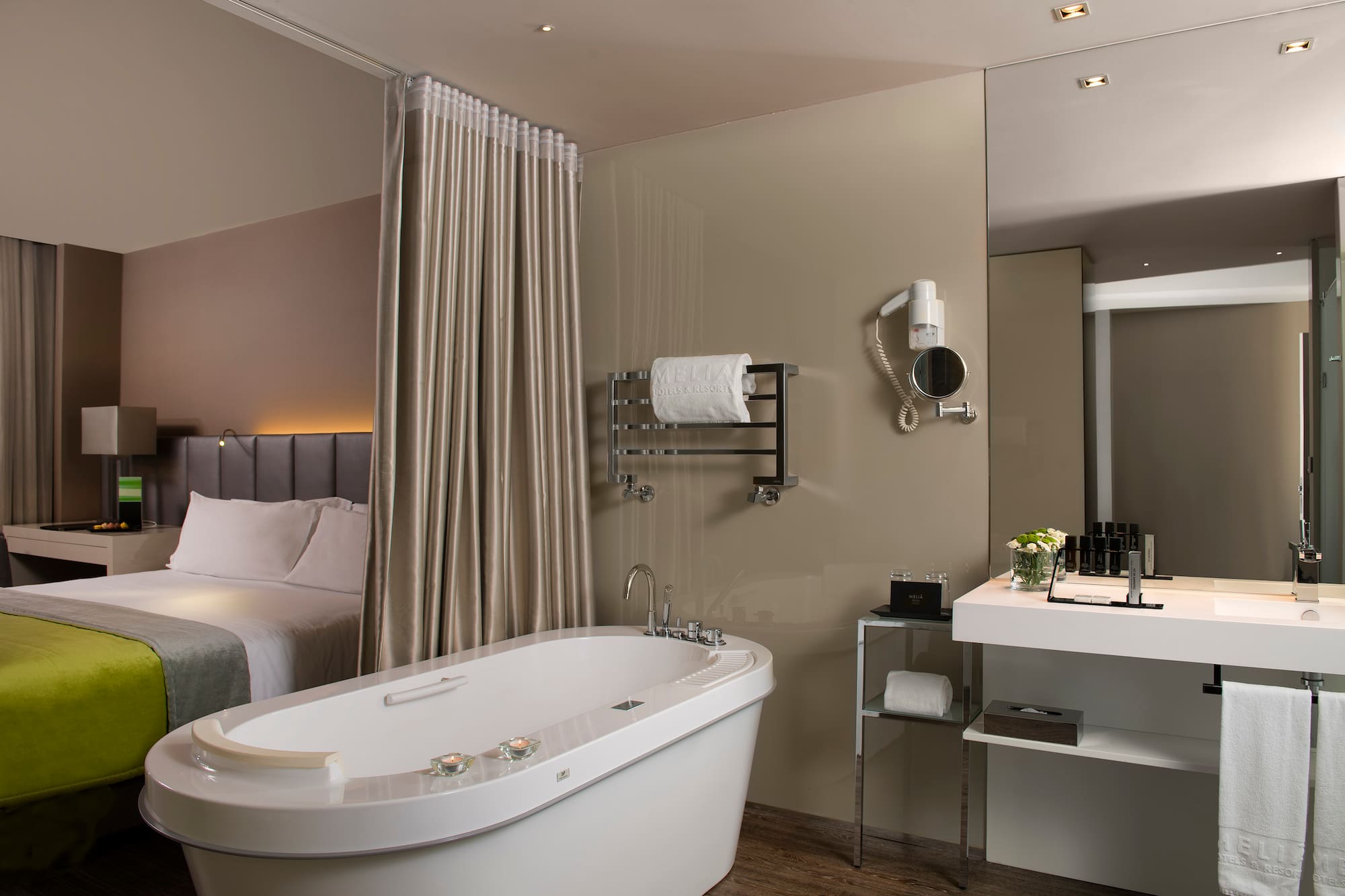 a bathroom with a bathtub and a bed