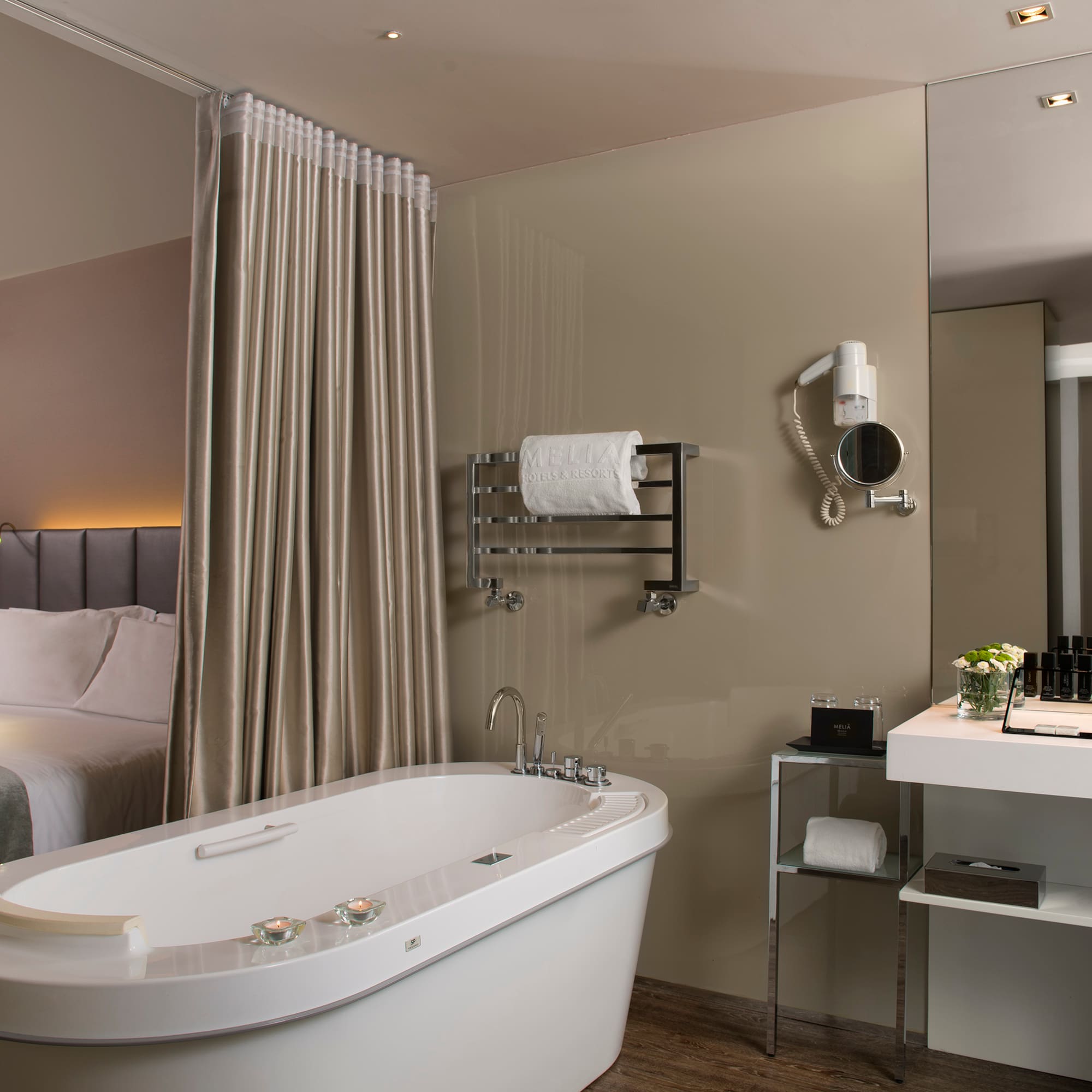 a bathroom with a bathtub and a bed