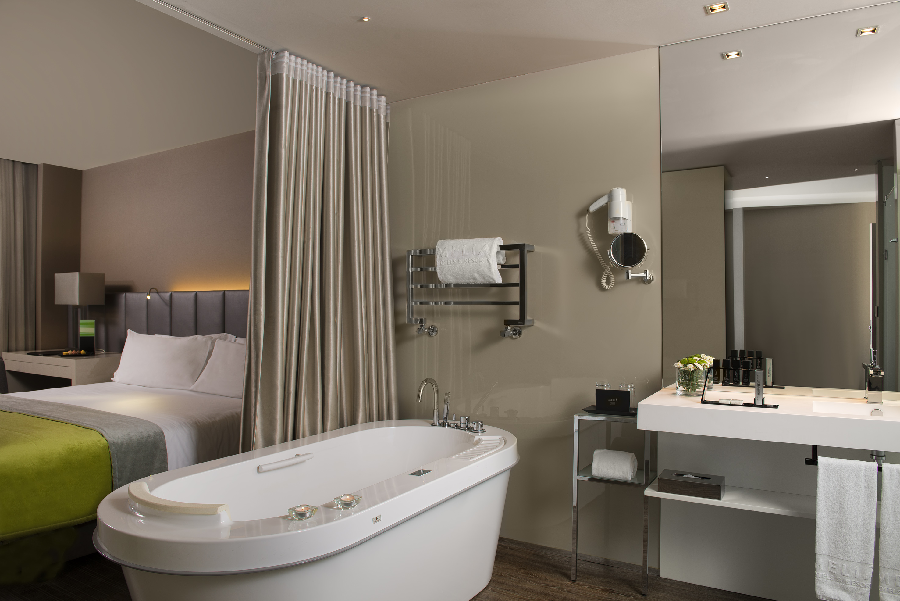 a bathroom with a bathtub and a bed