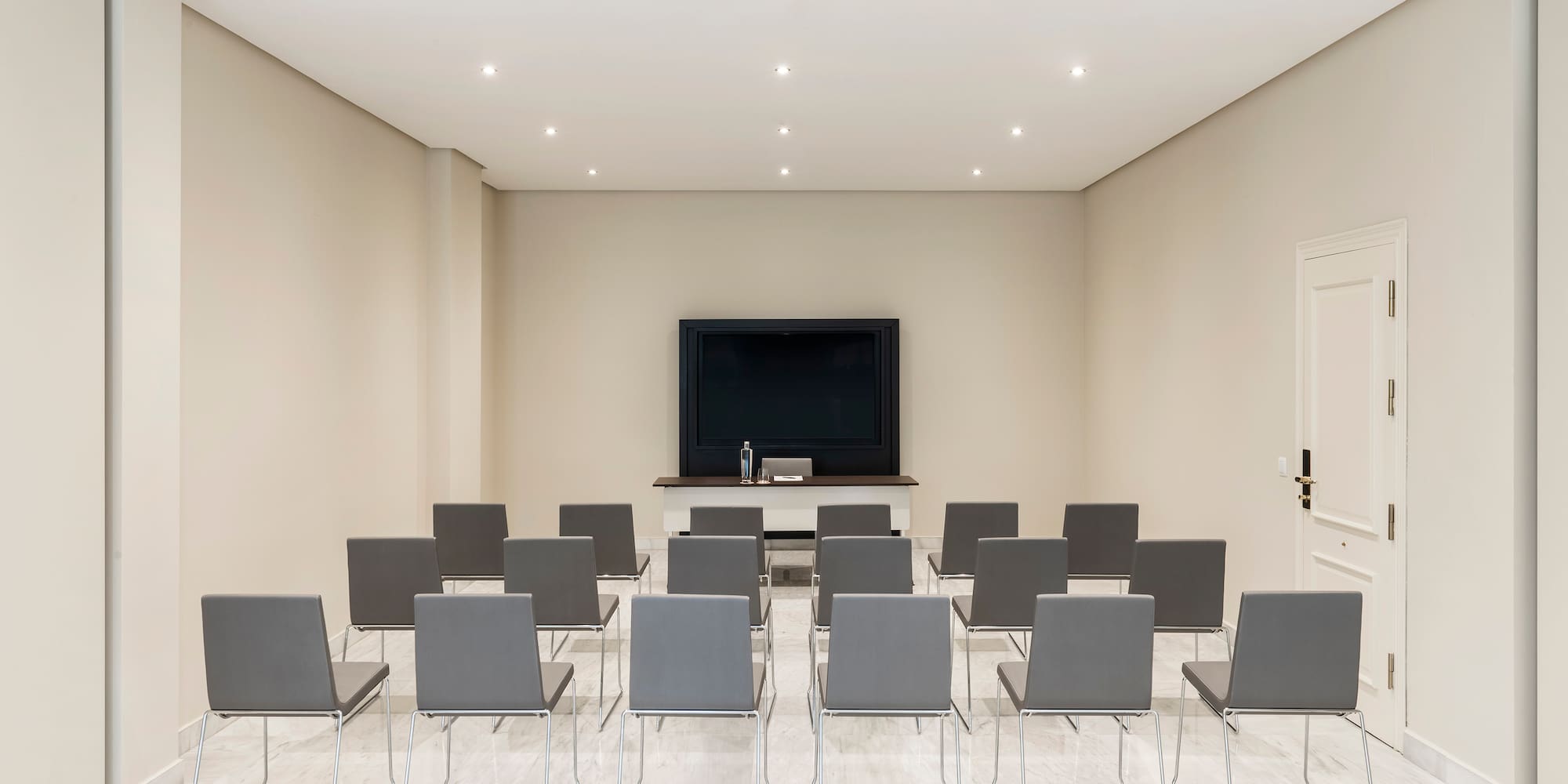 a room with many chairs and a television