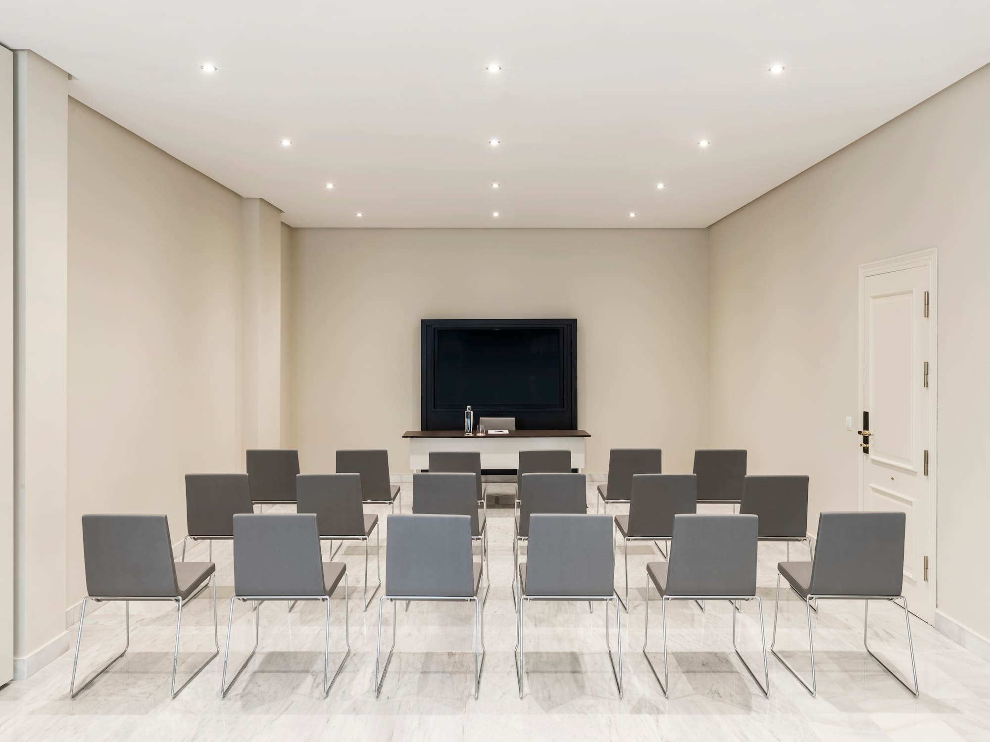 a room with many chairs and a television