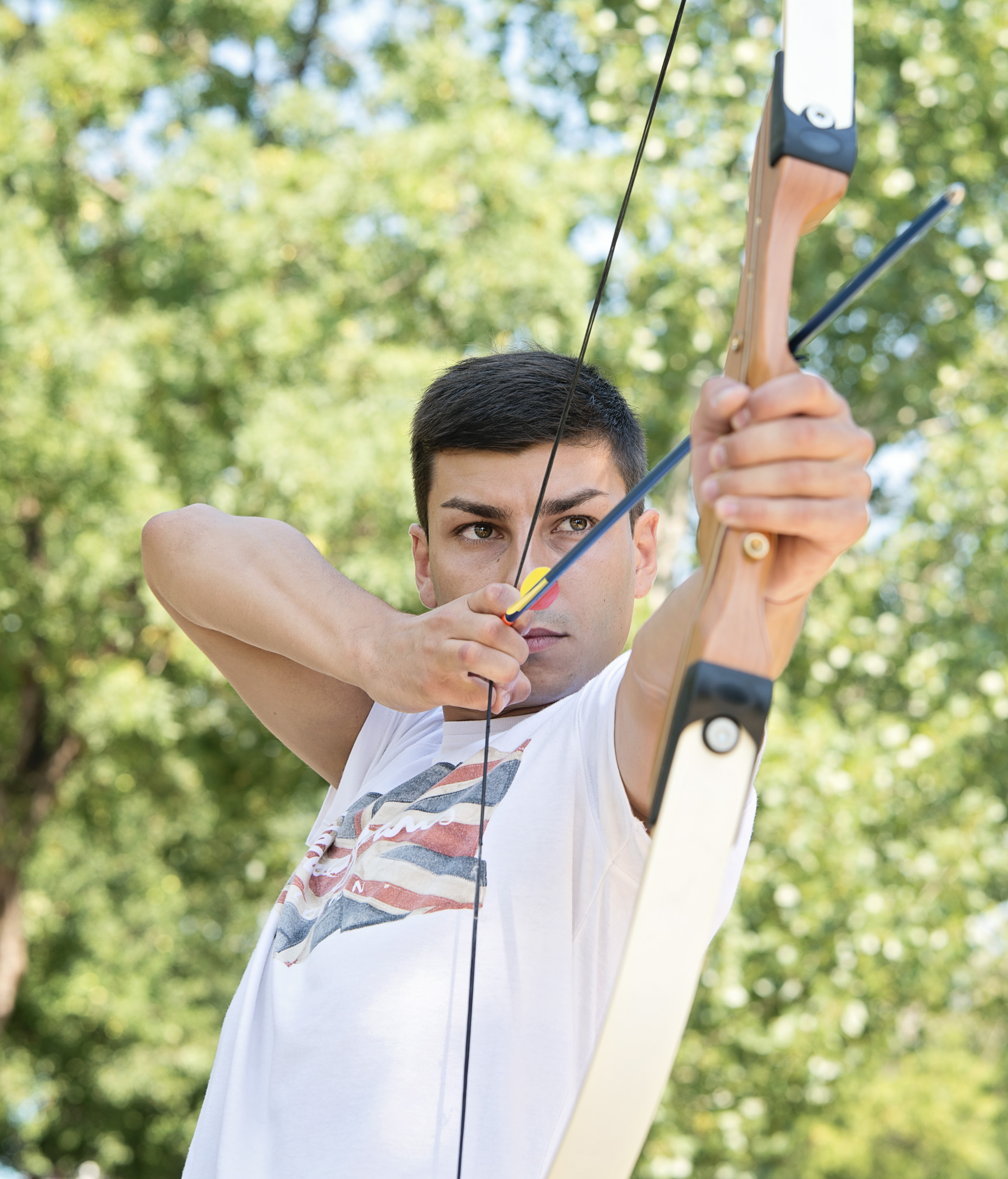 a man shooting a bow and arrow