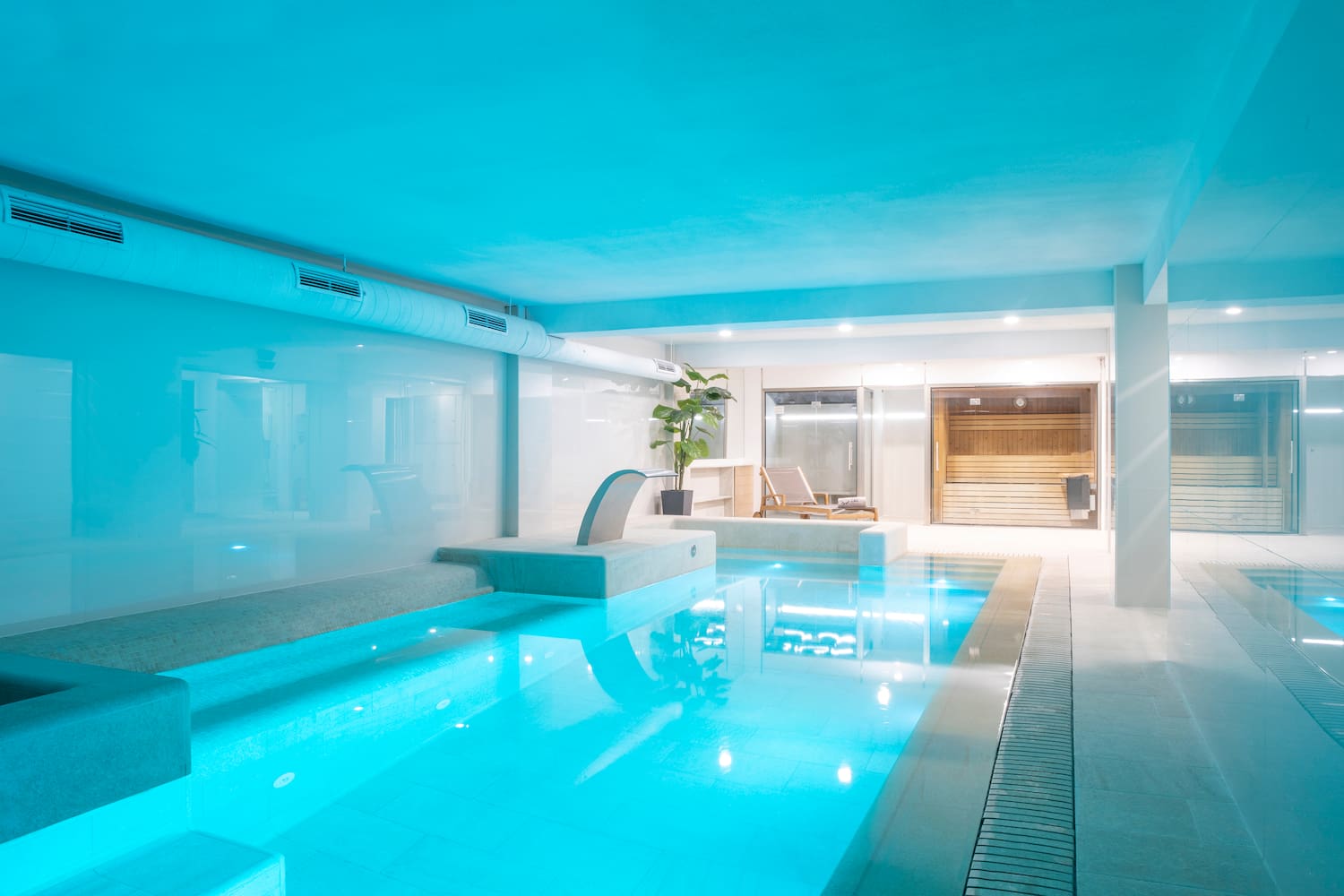 a indoor pool with a blue light