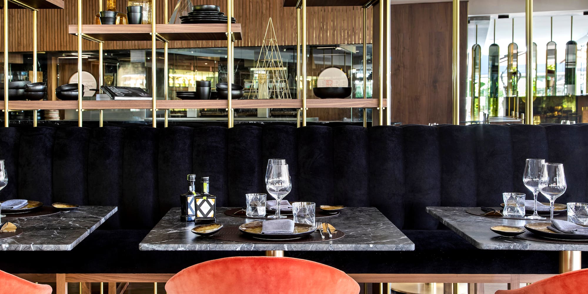 a table with a marble top and a red chair in a restaurant
