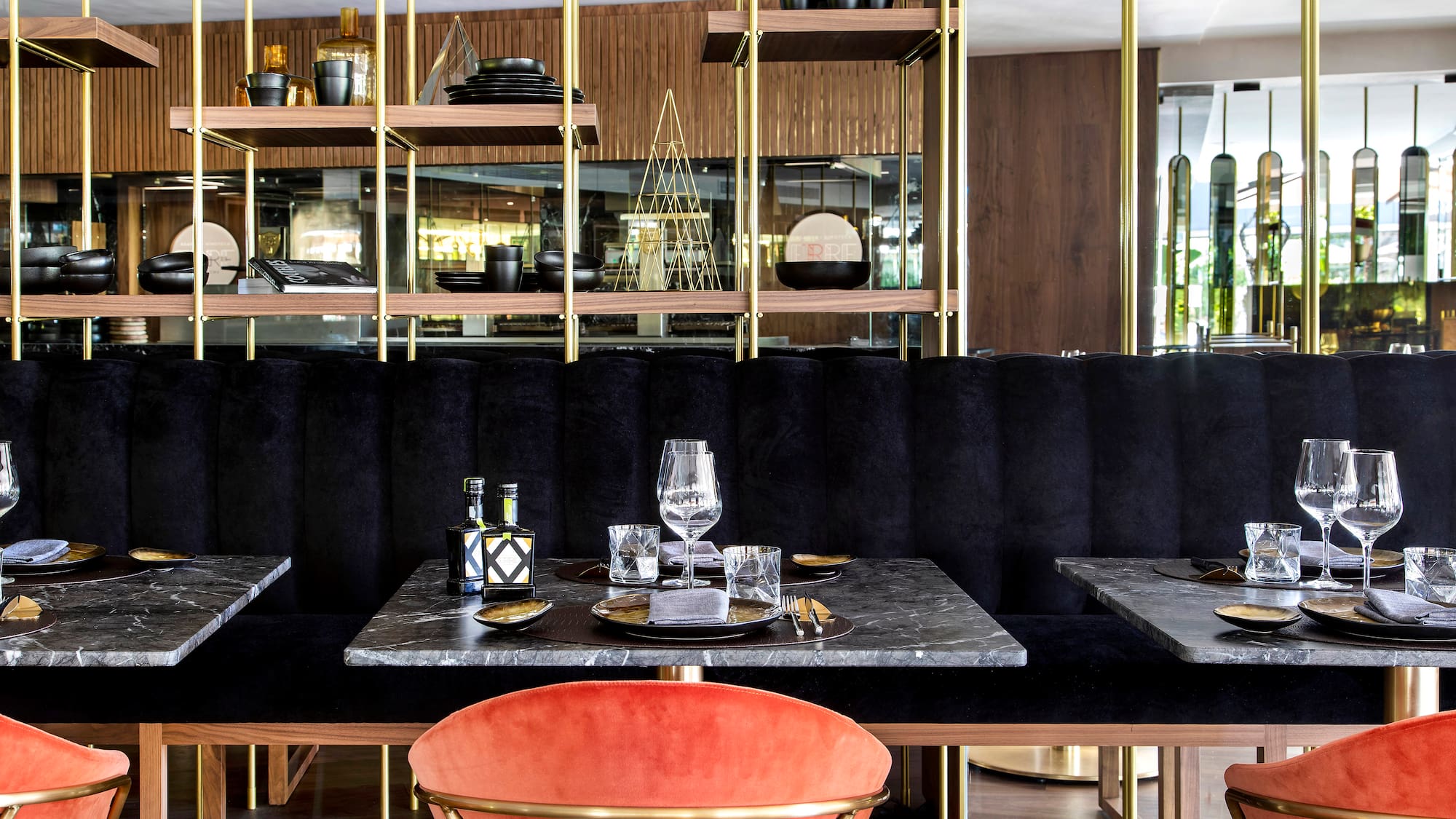a table with a marble top and a red chair in a restaurant