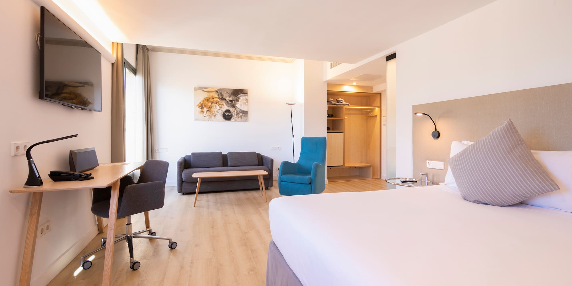 a room with a bed and a desk and chair