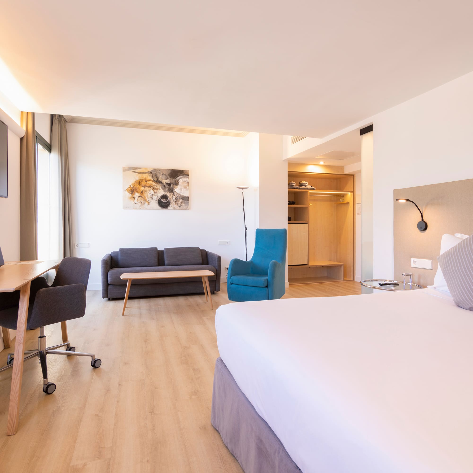 a room with a bed and a desk and chair