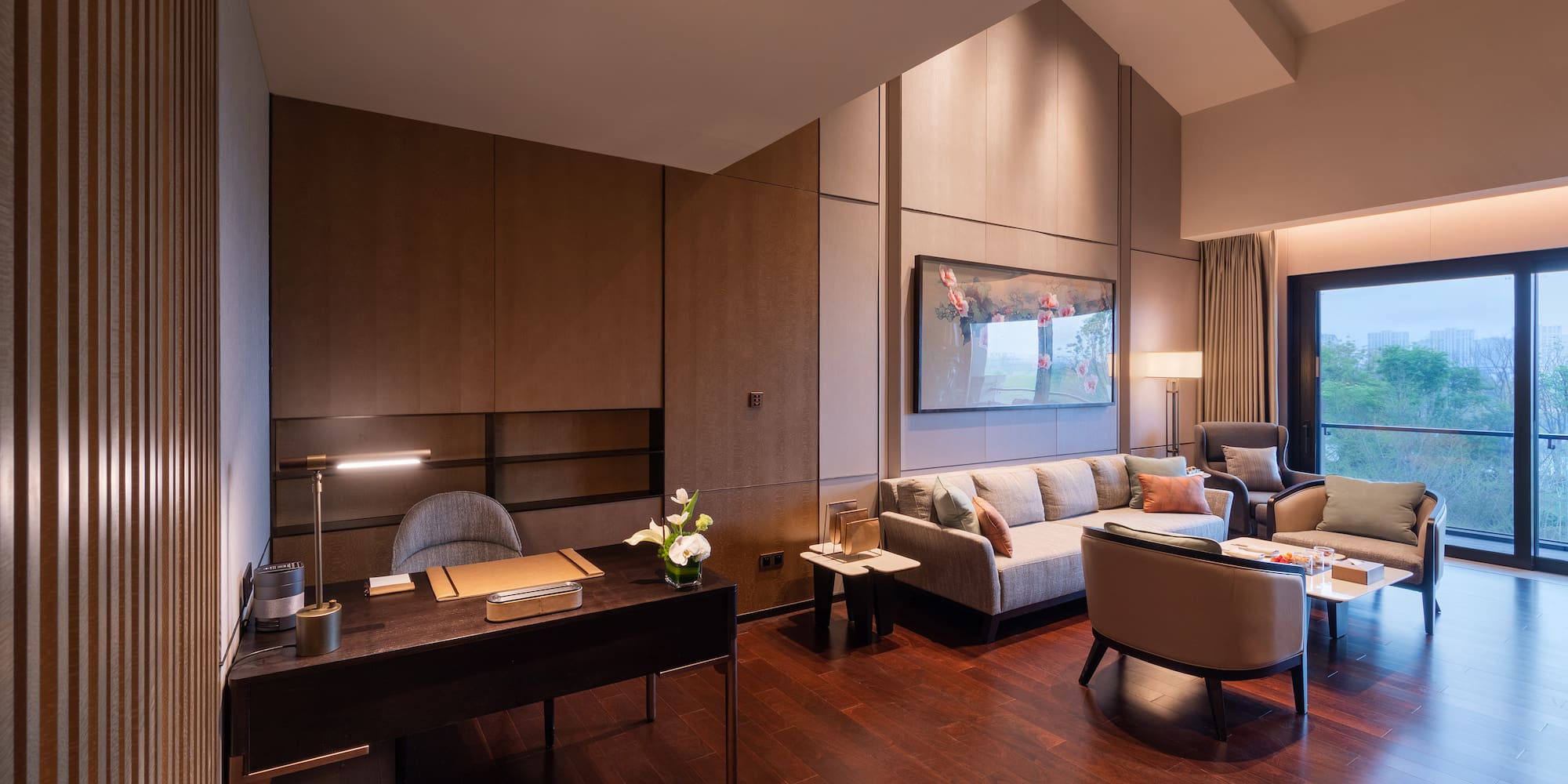 a room with a desk and couches