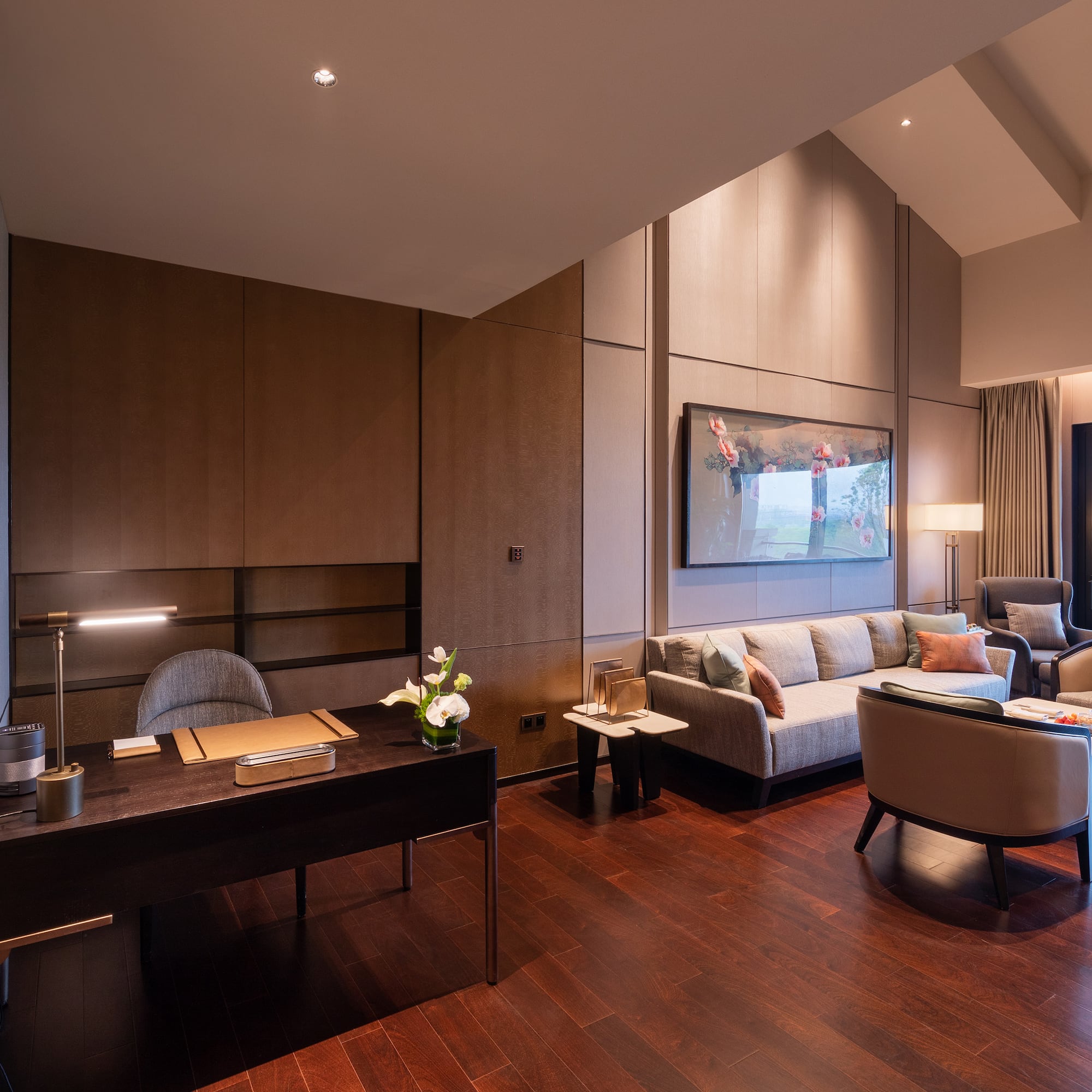 a room with a desk and couches