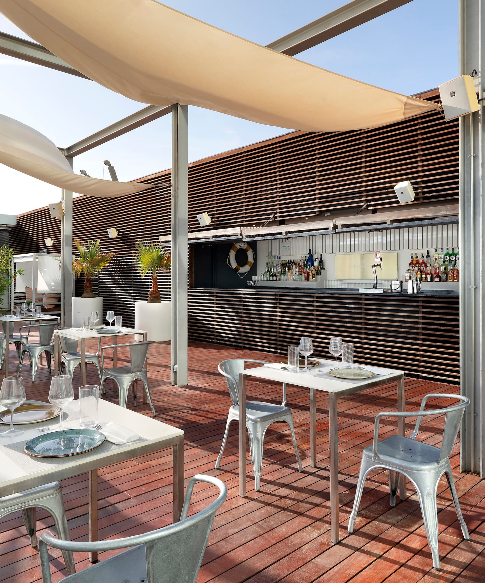 a patio with tables and chairs