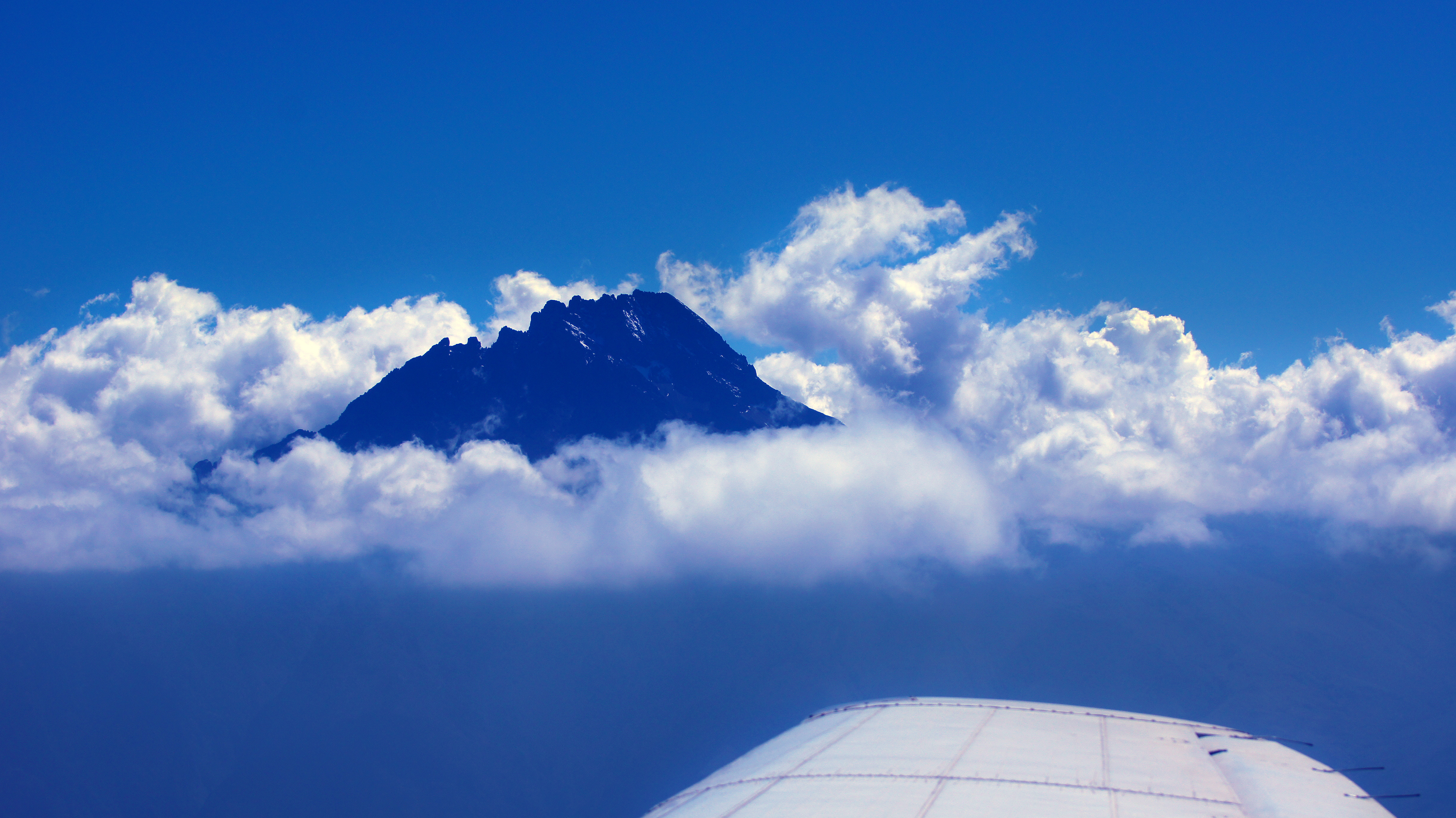 a mountain above clouds