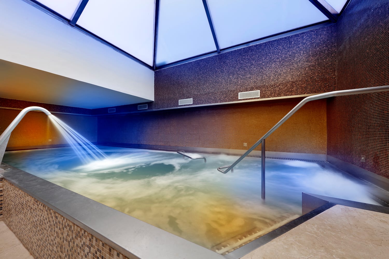 a pool with water and a skylight