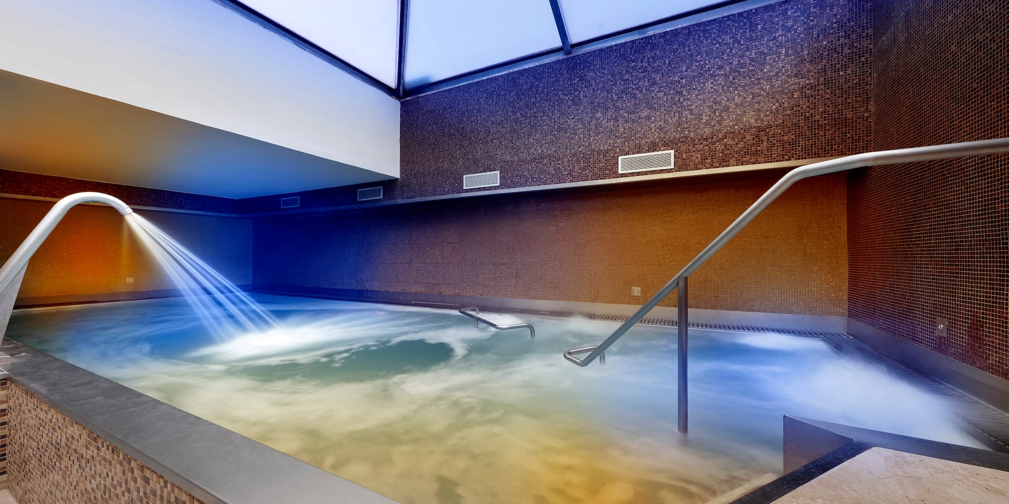 a pool with water and a skylight