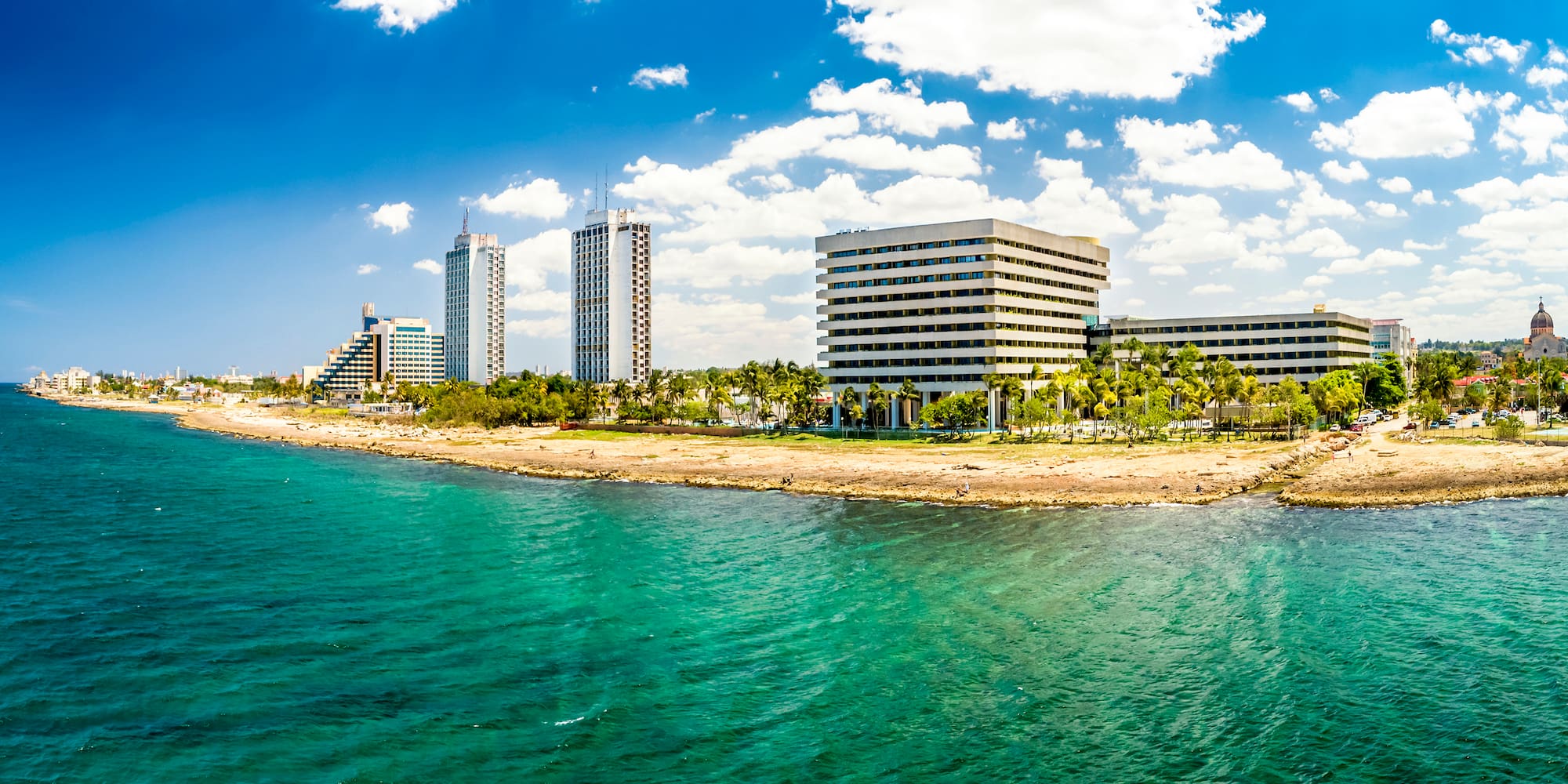 a body of water with buildings and trees