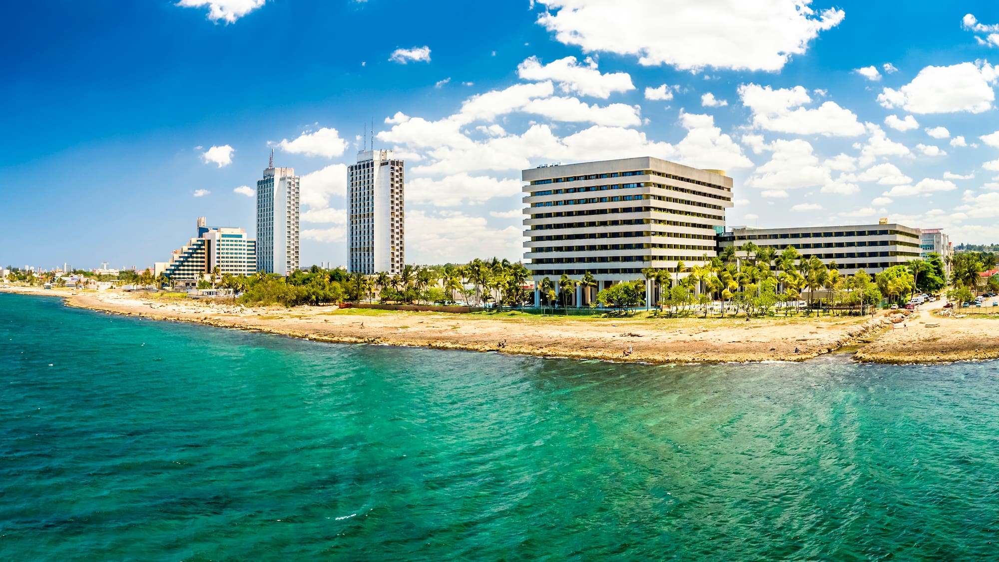 a body of water with buildings and trees