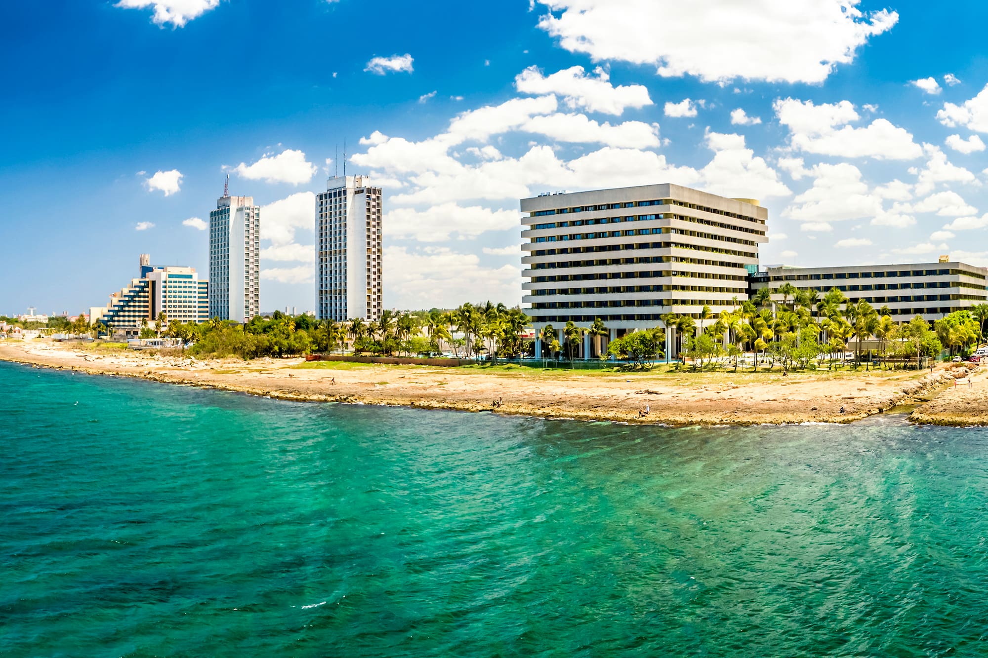 a body of water with buildings and trees