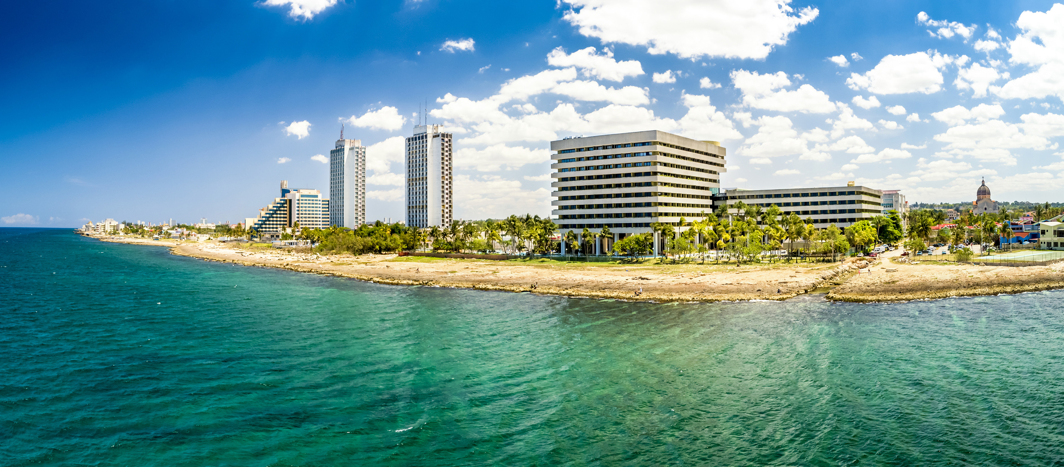 a body of water with buildings and trees