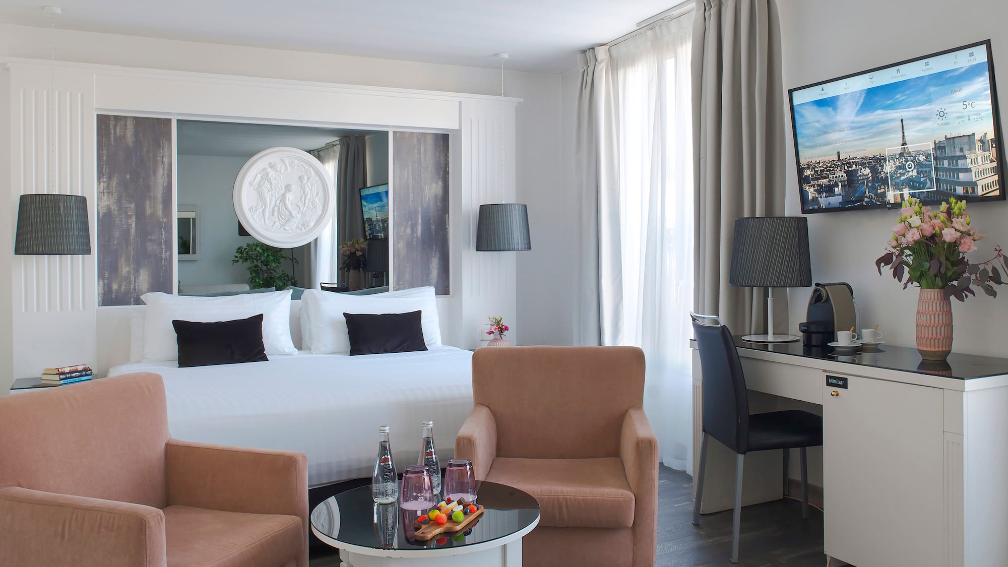 a room with a bed and a television