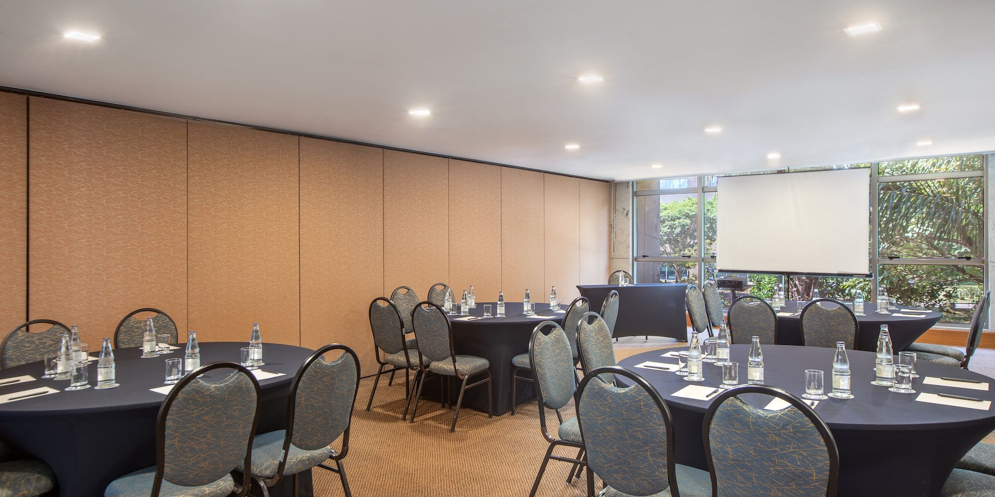 a room with round tables and chairs