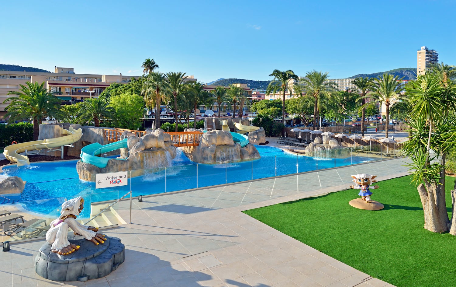 a water park with a slide and a playground