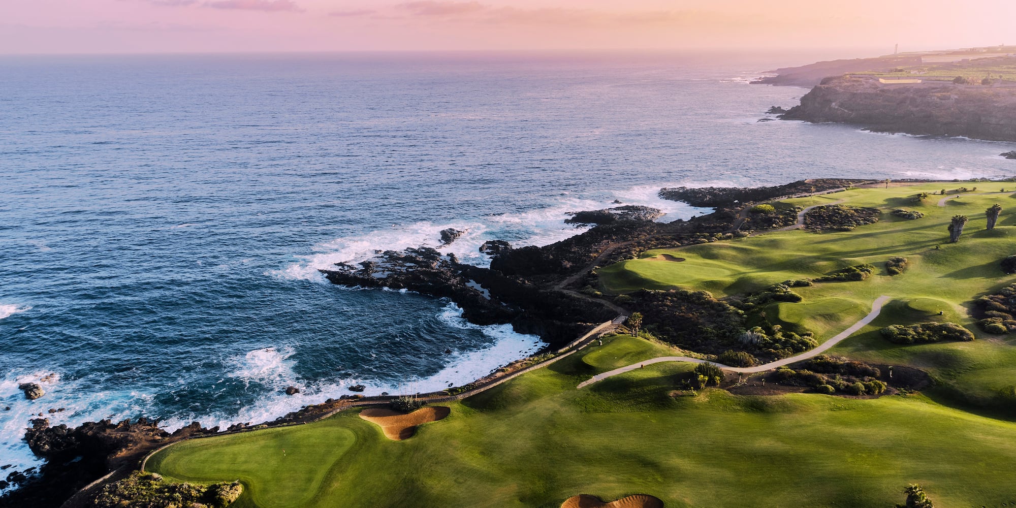 a golf course with a body of water