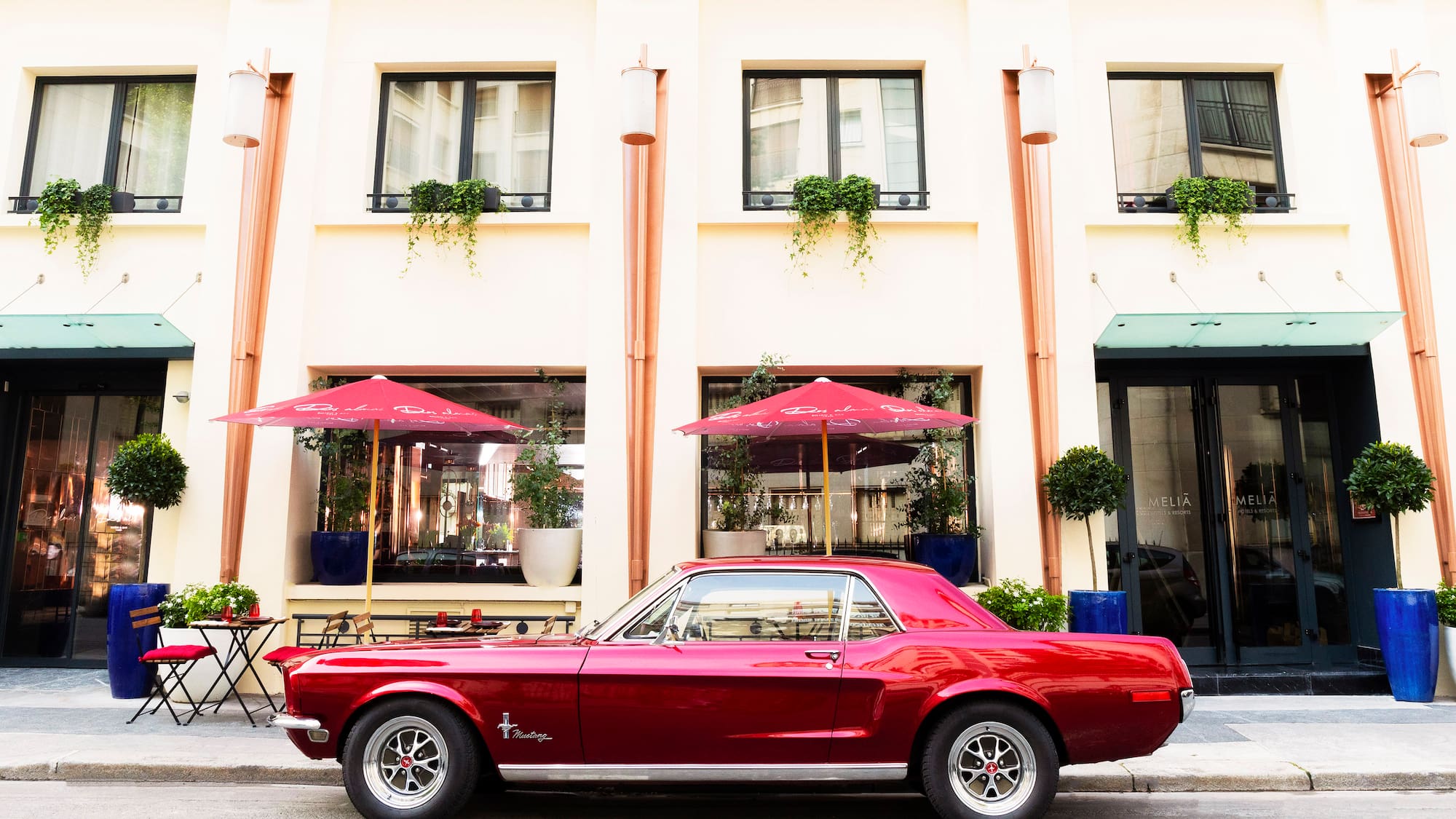 a red car parked in front of a building