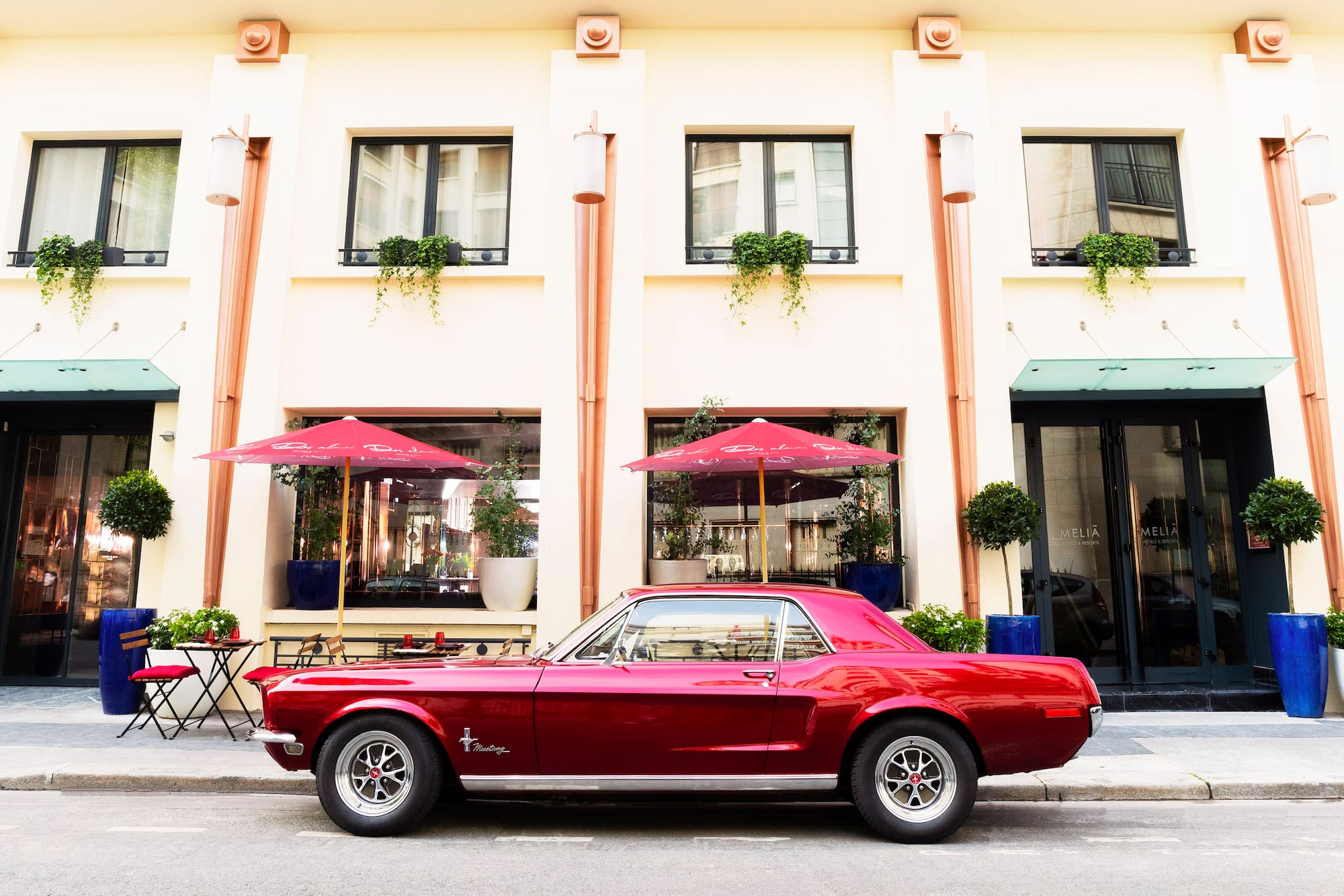 a red car parked in front of a building