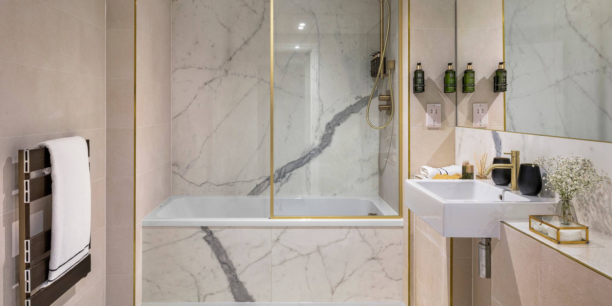 a bathroom with marble walls and a bathtub