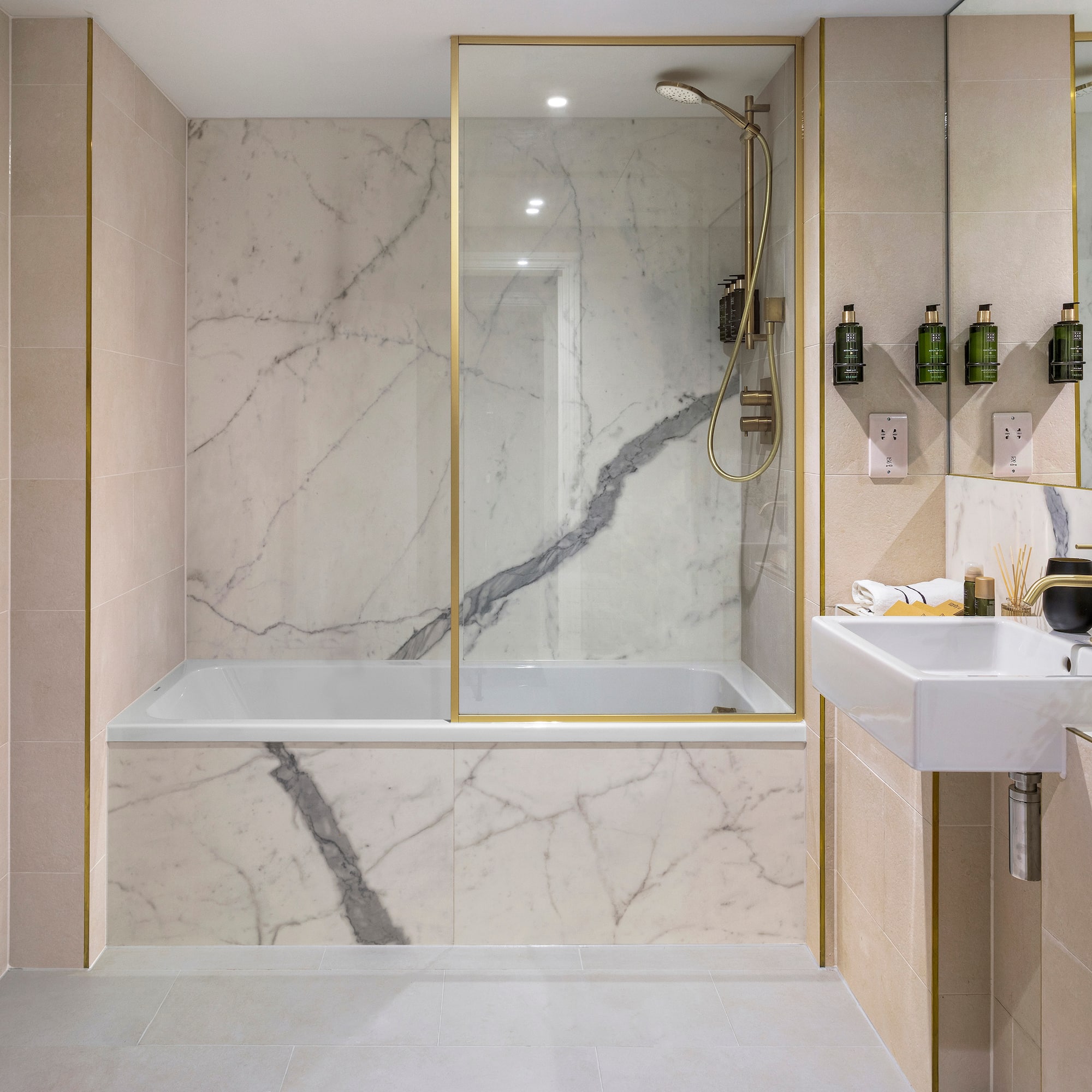 a bathroom with marble walls and a bathtub
