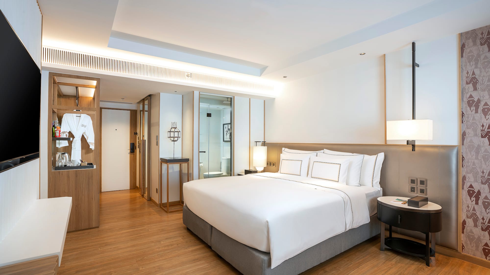 a room with a bed and a wood floor