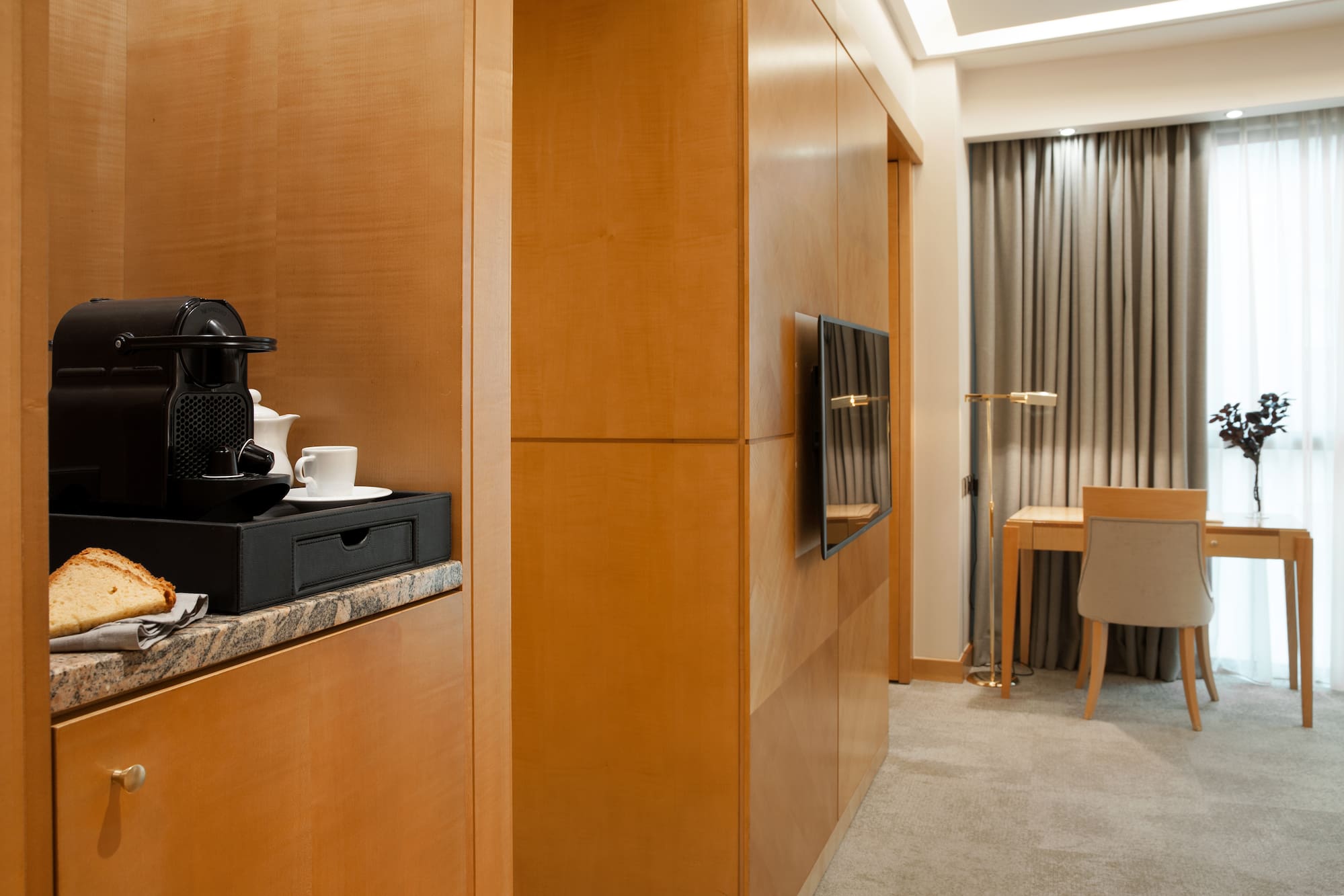 a room with a television and a coffee maker