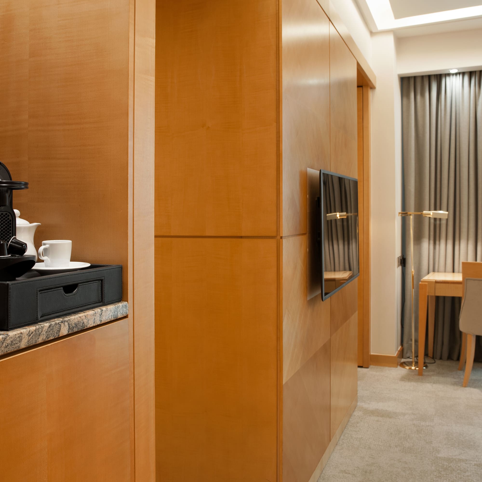 a room with a television and a coffee maker