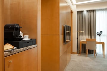 a room with a television and a coffee maker