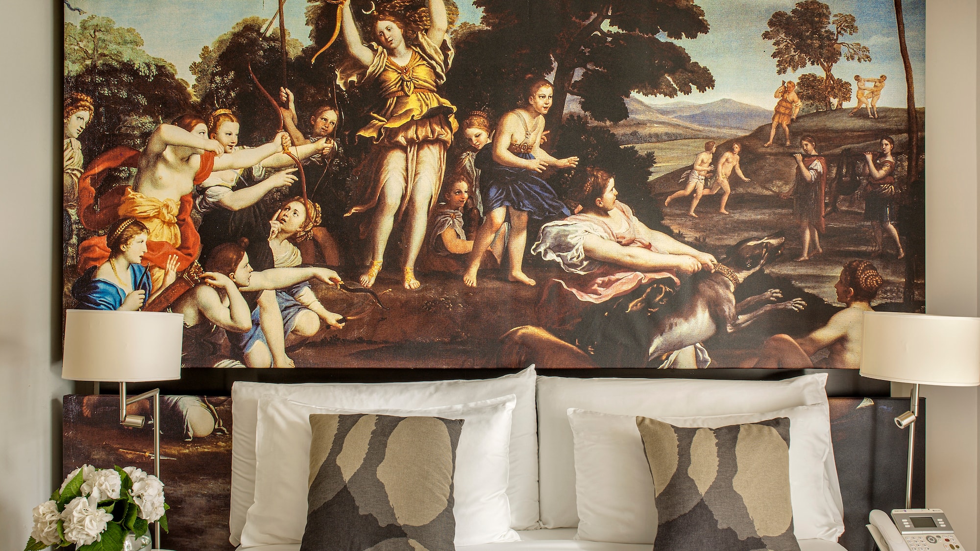 a bed with a painting above it