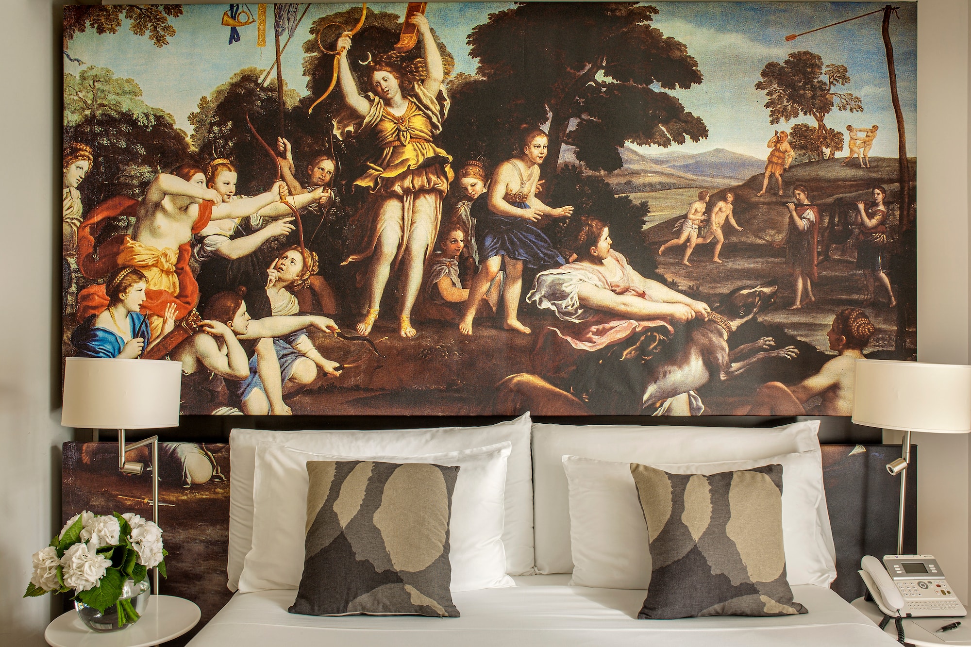 a bed with a painting above it